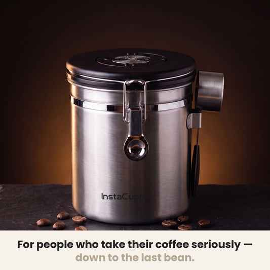 InstaCuppa Airtight Coffee Container 500g - Steel - on a dark kitchen counter with whole coffee beans