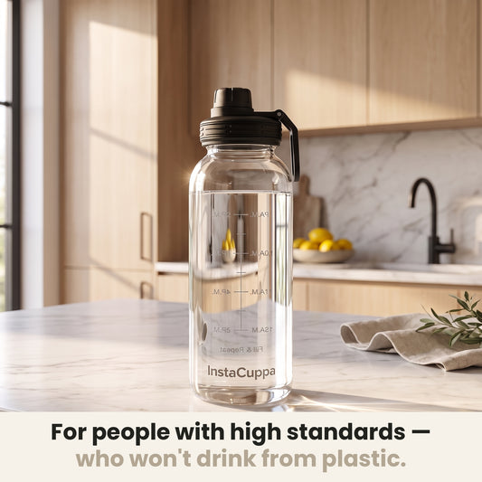 InstaCuppa Borosilicate Glass Water Bottle 1 Litre - Black - on a marble kitchen counter