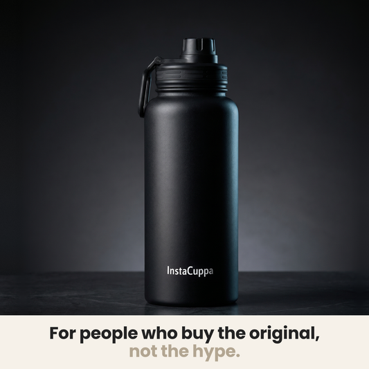 InstaCuppa Insulated Water Bottle 1L (1000 ml) - Black - bottle spotlit on dark stone, caption: for people who buy the original, not the hype