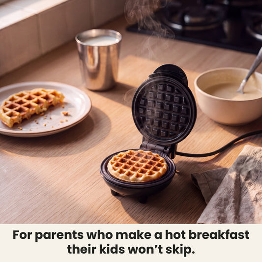 InstaCuppa Mini Waffle Maker 4 inch - Black - for parents who make a hot breakfast their kids won't skip: a fresh waffle on the kitchen counter beside a bowl of batter #color-black