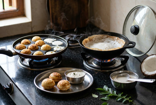 Best appam maker in India: a non-stick 12-cavity appe pan with golden paddu and an appachatty with soft lacy Kerala appam on a gas stove, with coconut chutney and fermented batter