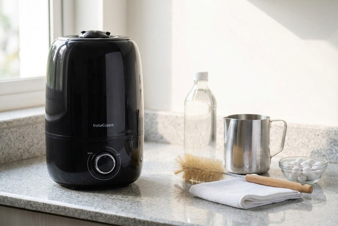 InstaCuppa 4L ultrasonic cool mist humidifier on a granite counter beside white vinegar, a steel jug of RO water, a bottle brush, a microfibre cloth and ceramic filter balls for cleaning and descaling