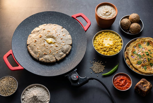 Bajra roti on the InstaCuppa electric tawa with bowls of bajra raab, khichdi, ladoo, cheela, pearl millet grains and bajra flour