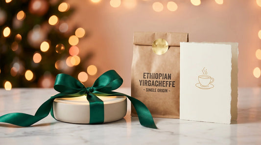 Coffee mug warmer gift-wrapped with ribbon, coffee bag, and greeting card