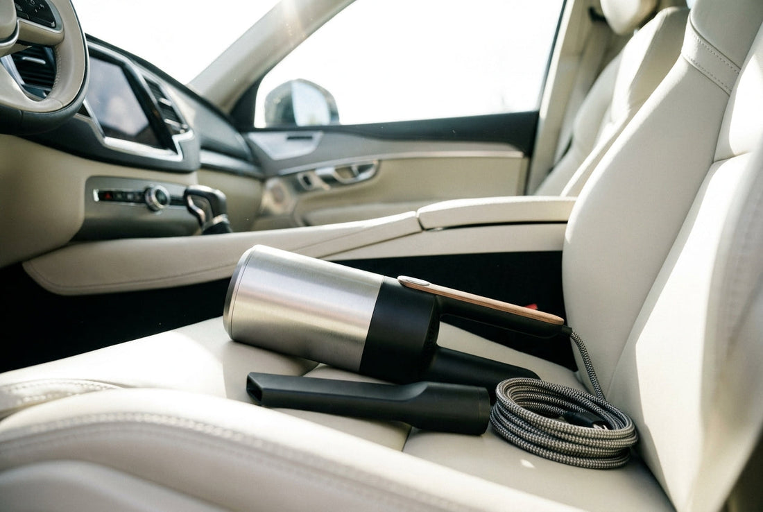 Compact handheld car vacuum cleaner with nozzle attachment on a clean car seat