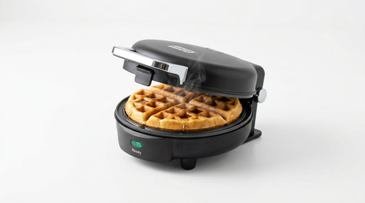 Mini waffle maker with golden waffle on white background