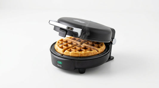 InstaCuppa Mini Waffle Maker cooking a golden 4-inch waffle on a white background — InstaCuppa