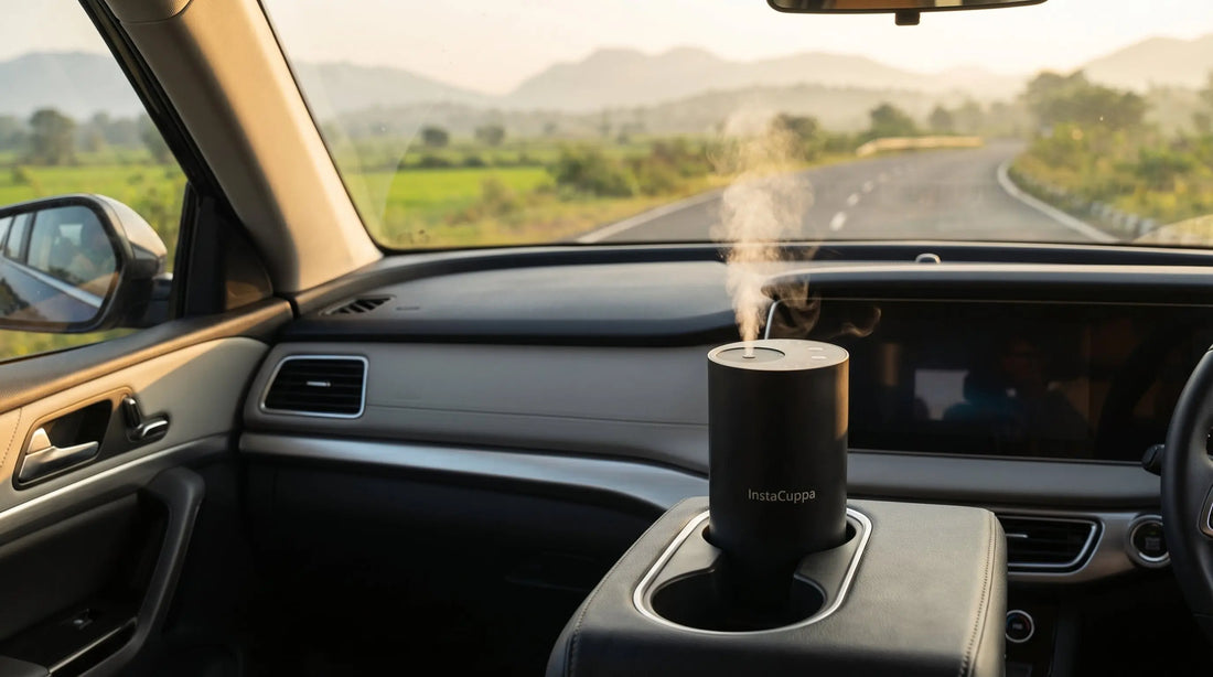 Portable aroma diffuser for car placed in cup holder with morning light and scenic road