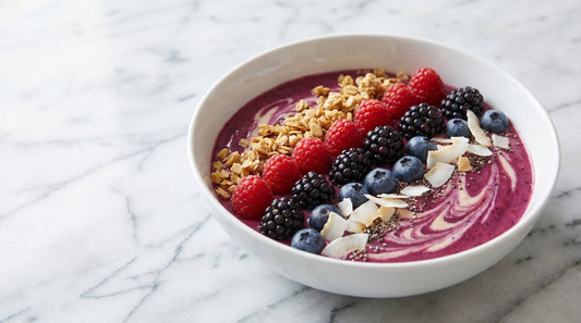 Berry smoothie bowl topped with blueberries granola and chia seeds