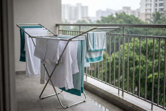 Best clothes drying rack in India 2026 with washed clothes on a rainy balcony
