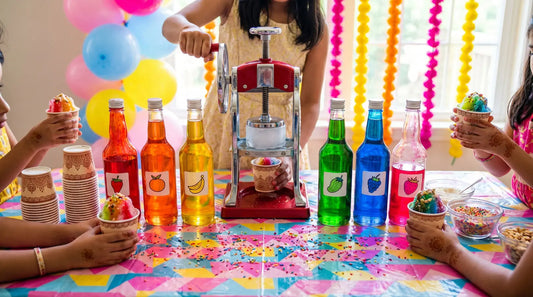 DIY gola bar setup for kids birthday party with colorful syrups, ice shaver, and festive decorations