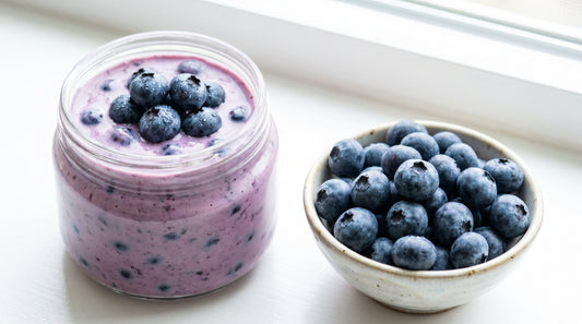 Creamy blueberry yogurt with fresh blueberries in ceramic bowl