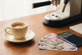 Espresso cup with Indian rupee notes, coins, and calculator for cost analysis concept