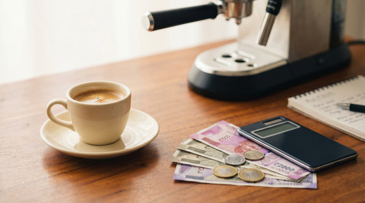 Espresso cup with Indian rupee notes, coins, and calculator for cost analysis concept