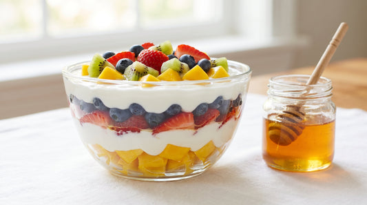 Homemade fruit yogurt with mixed berries and mango in glass bowl