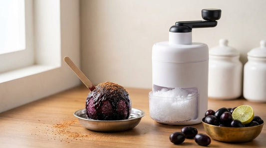 InstaCuppa Manual Ice Shaver beside a homemade kala khatta gola with jamun, chaat masala and lime