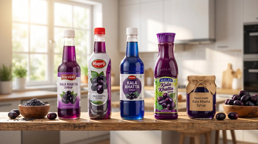 Kala khatta syrup bottles — Kalvert, Mapro, Malas, SWA brands and homemade jar with jamun fruit on wooden shelf