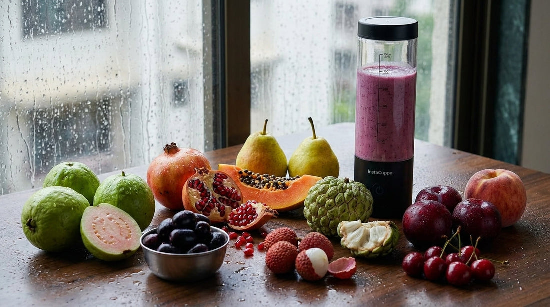 Monsoon fruits in India - guava, jamun, pomegranate, papaya, pears, custard apple, litchi, plums, cherries and a peach on a rain-wet table, with the InstaCuppa Ultra Slim Portable Blender Bottle filled with a jamun smoothie