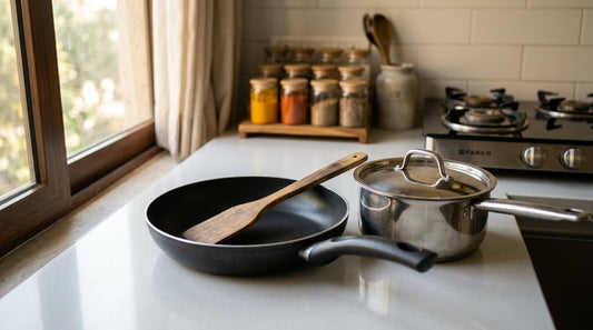 Non-stick cookware safety in Indian kitchen - pan and steel pot with wooden spatula