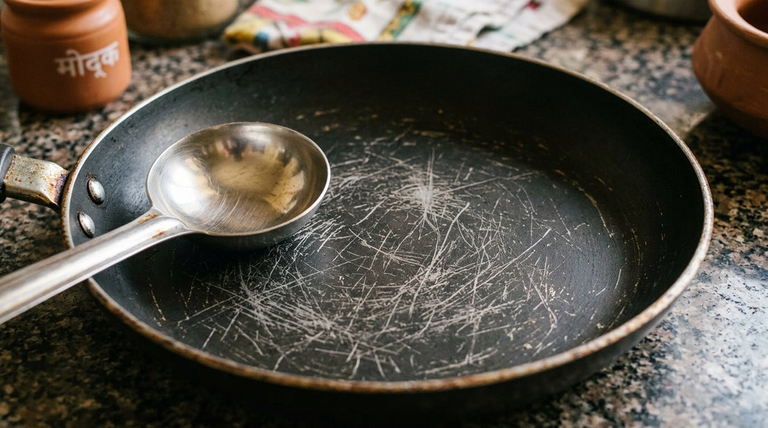 Scratched non-stick pan with steel karchi - is it safe to cook