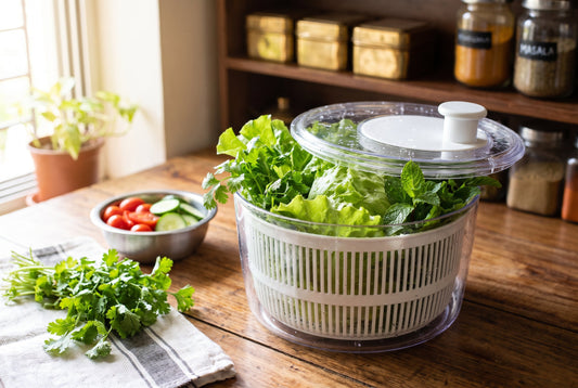 Salad spinner drying fresh coriander, mint and lettuce on an Indian kitchen counter