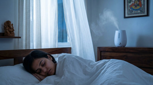 Humidifier on a bedside table releasing cool mist in a dimly lit Indian bedroom at night