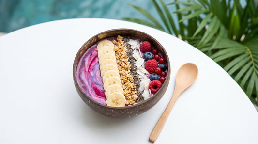 Thick smoothie bowl with fresh berries granola and chia seeds on an Indian kitchen table