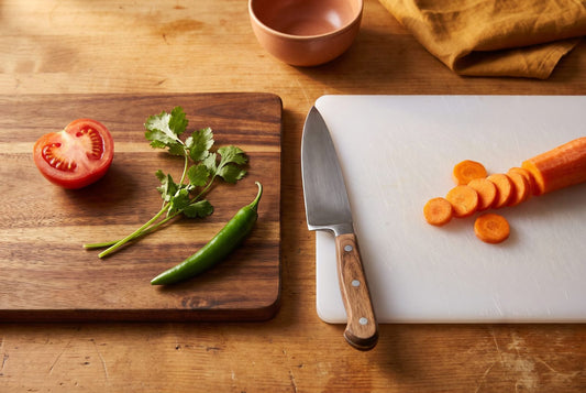 Wooden vs plastic chopping board side by side on an Indian kitchen counter