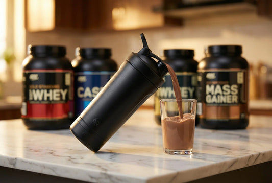 Electric shaker bottle complete guide - shaker pouring smooth protein shake surrounded by supplements