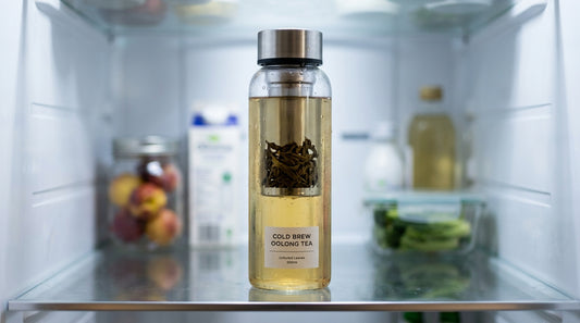 Cold brewed tea in glass infuser bottle in refrigerator
