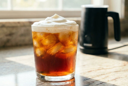 Iced cold coffee with cold foam made with milk frother