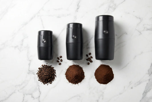 Three InstaCuppa electric coffee grinders V1 V2 V3 with ground coffee showing grind quality differences