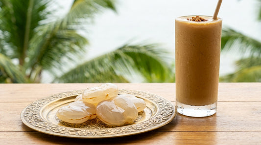 Fresh ice apples on brass plate with coconut jaggery smoothie and palm trees