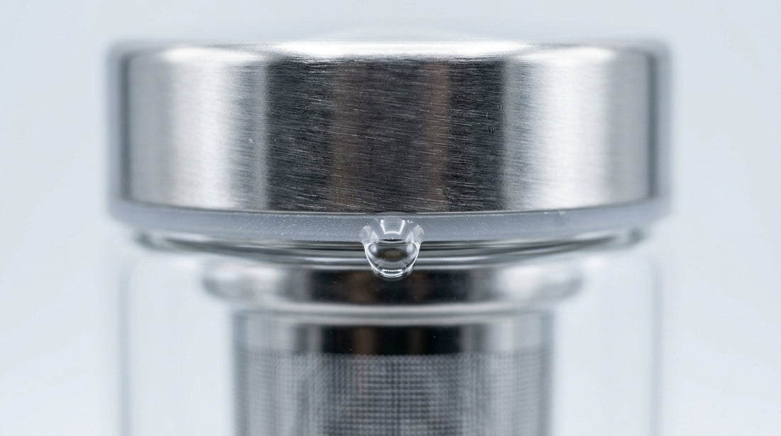 Tea infuser bottle with water drop on lid seal close-up