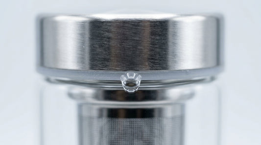 Tea infuser bottle with water drop on lid seal close-up