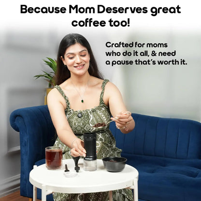 InstaCuppa manual coffee grinder on table, mom preparing fresh brew, ideal coffee gadget for busy multitasking moms - InstaGrind Manual Pro
