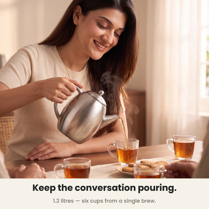 InstaCuppa Stainless Steel Teapot - pouring tea for guests at the table · 1.2 L · 6 cups