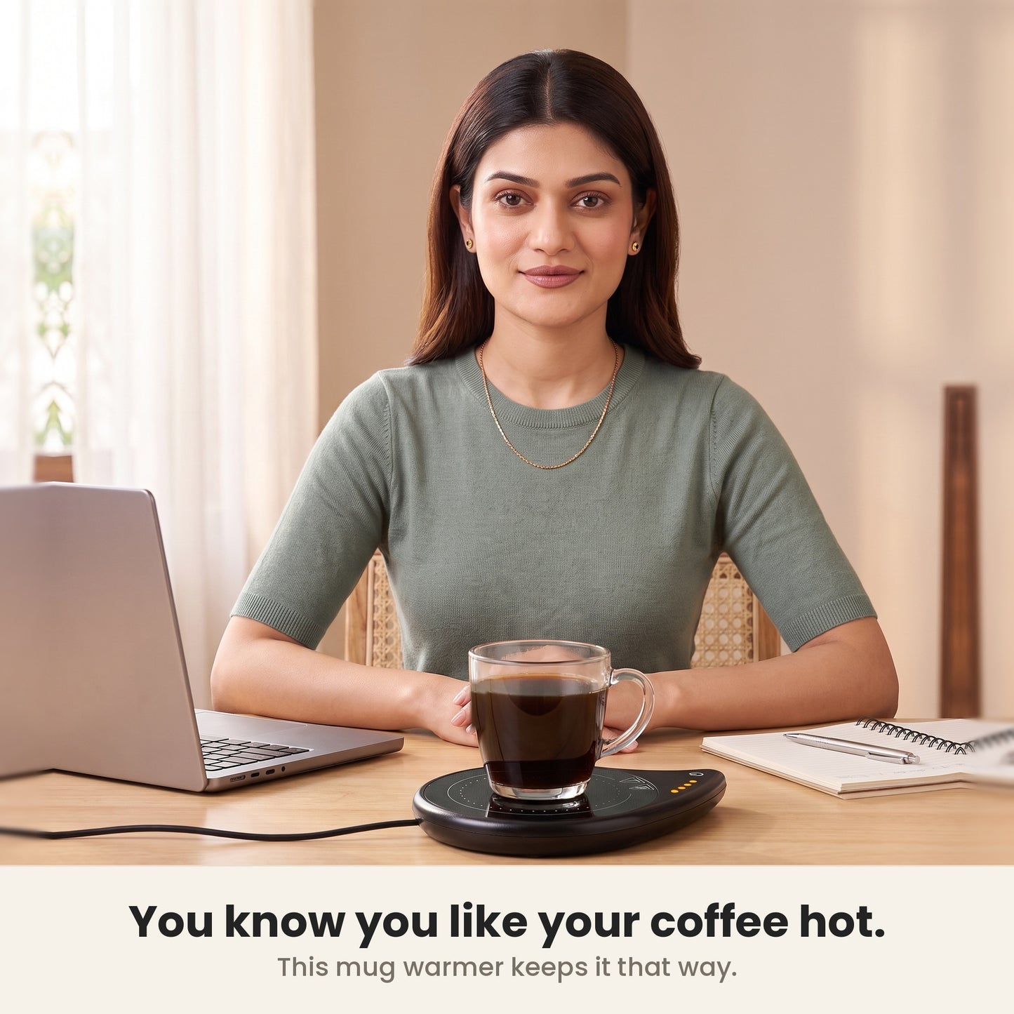 InstaCuppa coffee mug warmer for desk keeping a woman's coffee hot as she works at her laptop