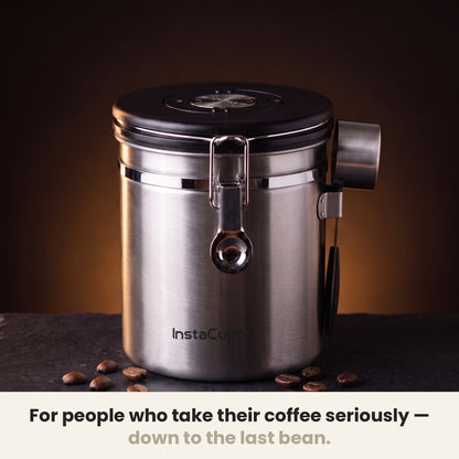 InstaCuppa Airtight Coffee Container 500g - Steel - on a dark kitchen counter with whole coffee beans