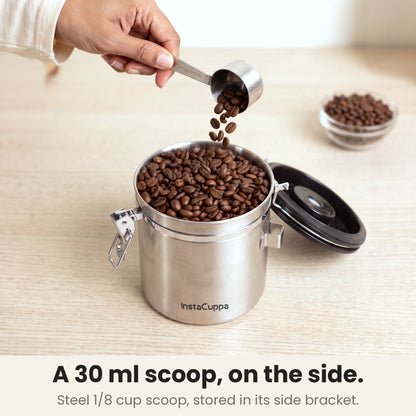 Airtight coffee container - Steel - 1/8 cup 30 ml stainless steel scoop pouring coffee beans into the canister, stored in its side bracket