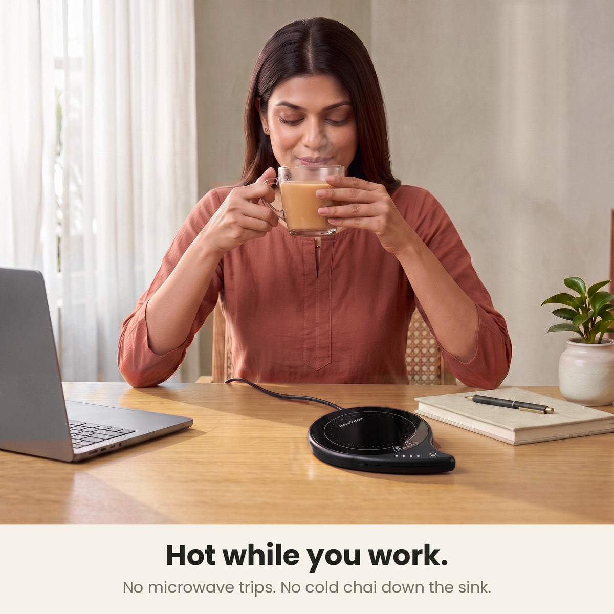 InstaCuppa coffee mug warmer for desk — woman sipping hot chai at her laptop, no microwave trips