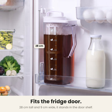 InstaCuppa cold brew coffee maker — 28 cm tall and 9 cm wide jug of cold brew standing in a fridge door shelf next to a milk bottle