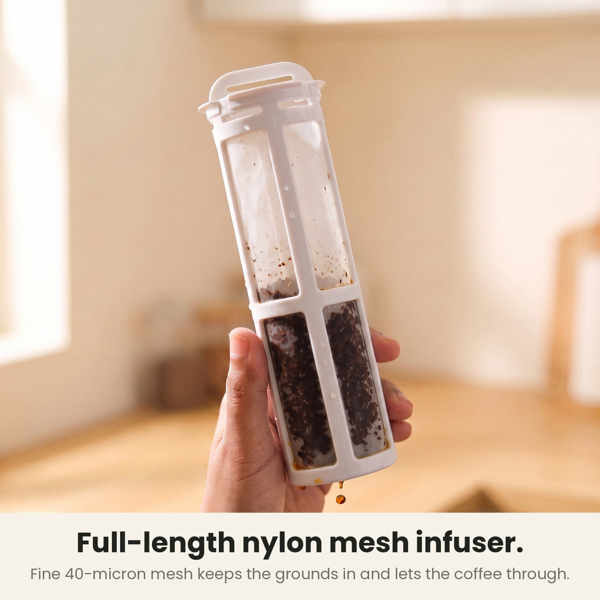 InstaCuppa cold brew coffee maker — full-length nylon mesh infuser held in hand, the fine 40-micron mesh keeping wet coffee grounds inside