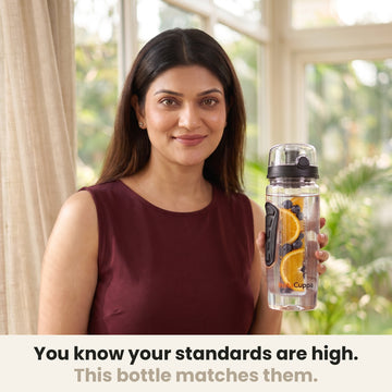 InstaCuppa Fruit Infuser Water Bottle 1 Litre - Black - woman holding the bottle in a sunlit room, made for your standards