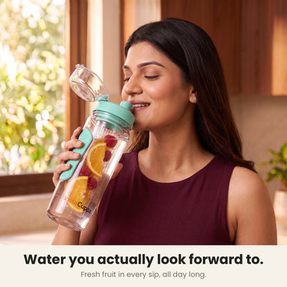 InstaCuppa Fruit Infuser Water Bottle 1 Litre - Green - woman sipping fruit-infused water from the flip-top lid