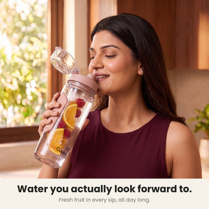 InstaCuppa Fruit Infuser Water Bottle 1 Litre - Rose - woman sipping fruit-infused water from the flip-top lid