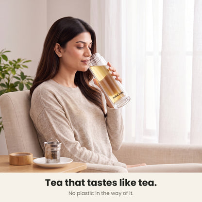 InstaCuppa Glass Tea Infuser Bottle 450 ML - woman sipping tea with the infuser lifted out