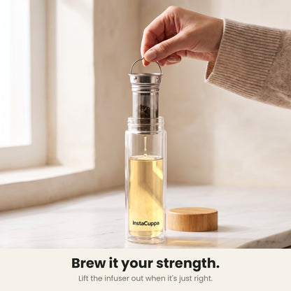 InstaCuppa Glass Tea Infuser Bottle 450 ML - brew it your strength: lifting the 2-in-1 steel infuser out by its wire handle when the tea is just right