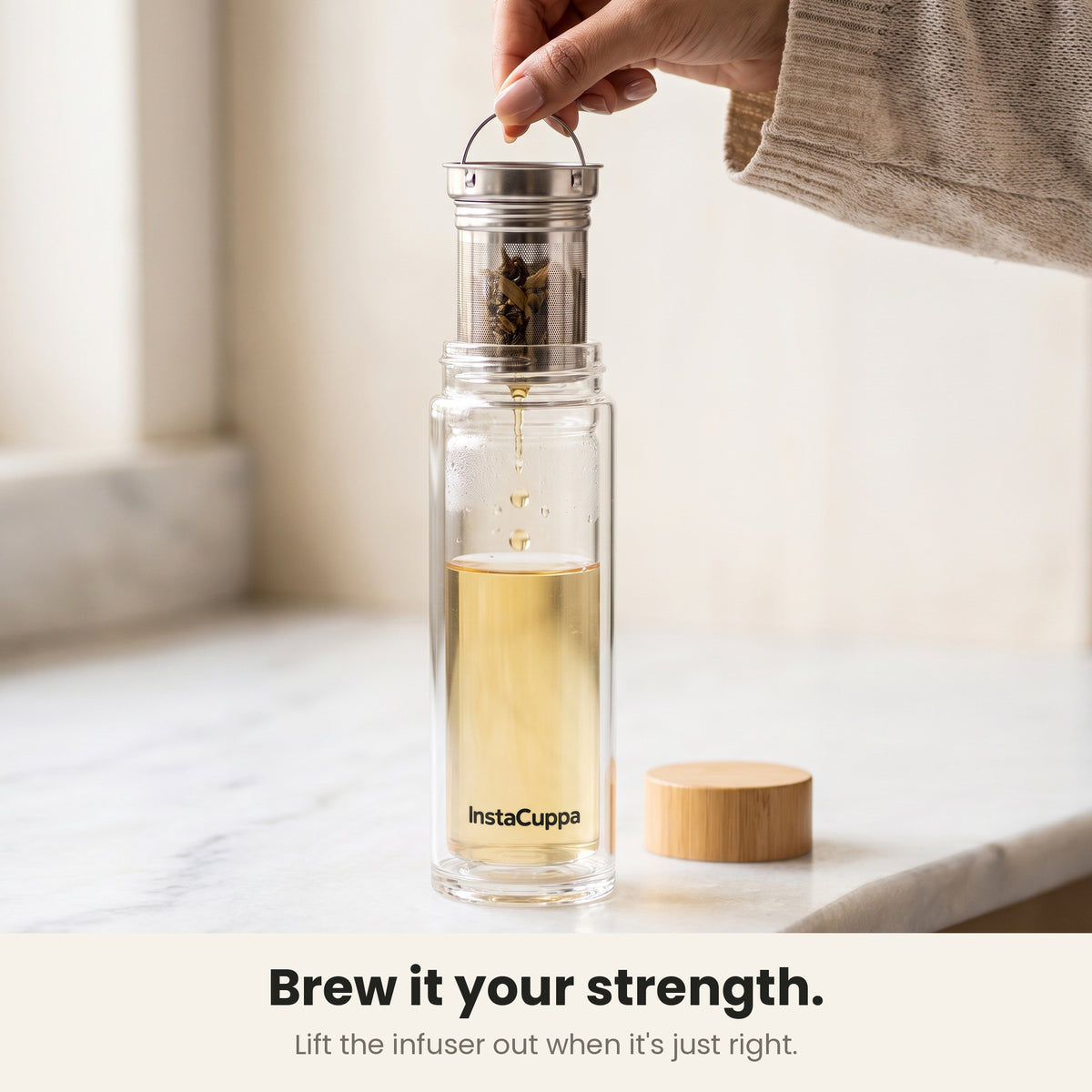 InstaCuppa Glass Tea Infuser Bottle 450 ML - lifting the removable stainless steel infuser to control brew strength