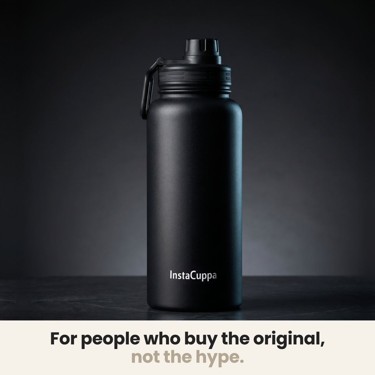InstaCuppa Insulated Water Bottle 1L (1000 ml) - Black - bottle spotlit on dark stone, caption: for people who buy the original, not the hype